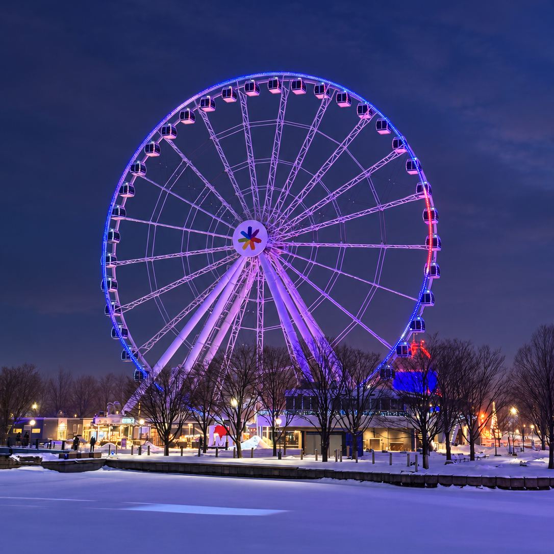 La Grande roue de Montréal illuminée au Vieux-Port, un soir d’hiver enneigé