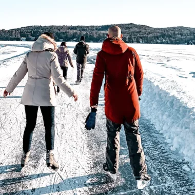 Patineurs sur une patinoire extérieure enneigée en hiver
